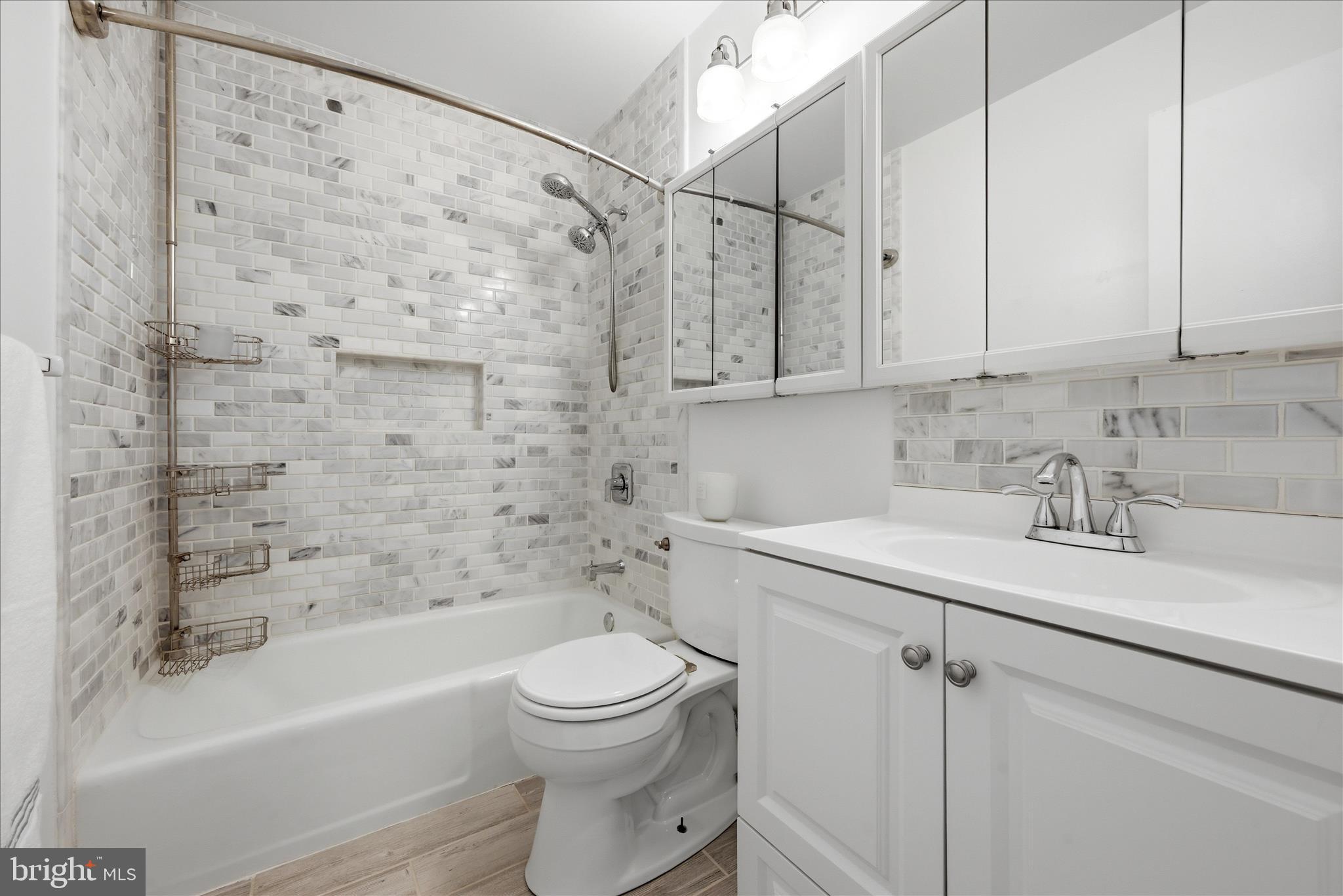 5446 Lighthouse Lane Burke, VA 22015 - Photo 16 of 36 a bathroom with a sink toilet and shower