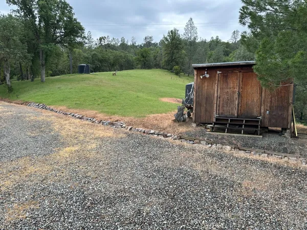 a backyard of a house with barbeque oven