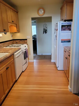 a kitchen with stainless steel appliances granite countertop a refrigerator and a stove top oven