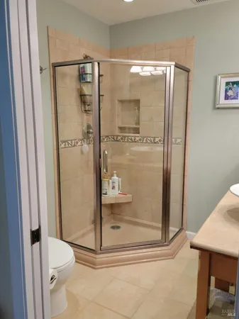 a bathroom with a glass shower door