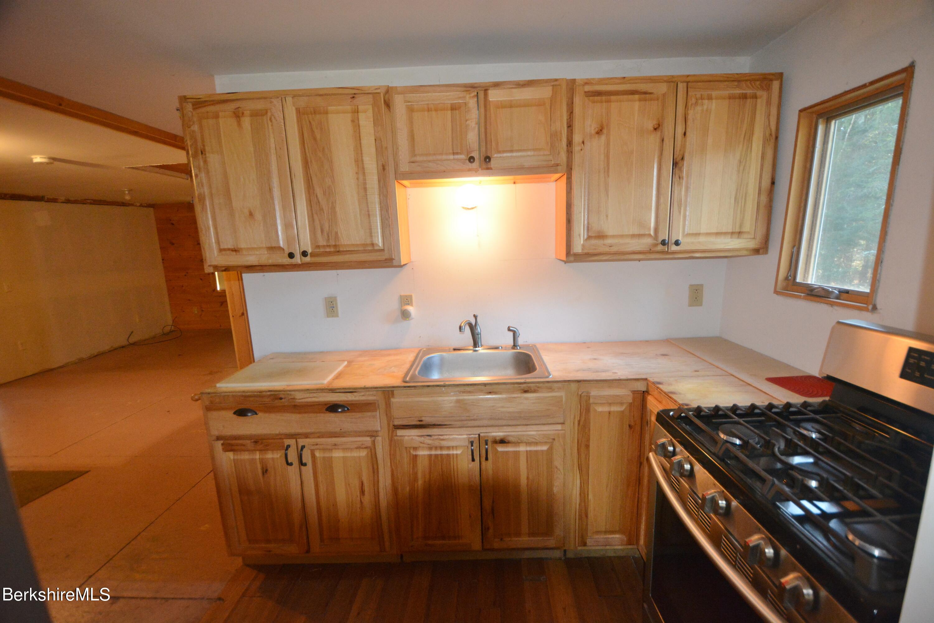150 Cold Spring Road Sandisfield, MA 01255 - Photo 3 of 9 a kitchen with stainless steel appliances granite countertop a stove a sink and a microwave