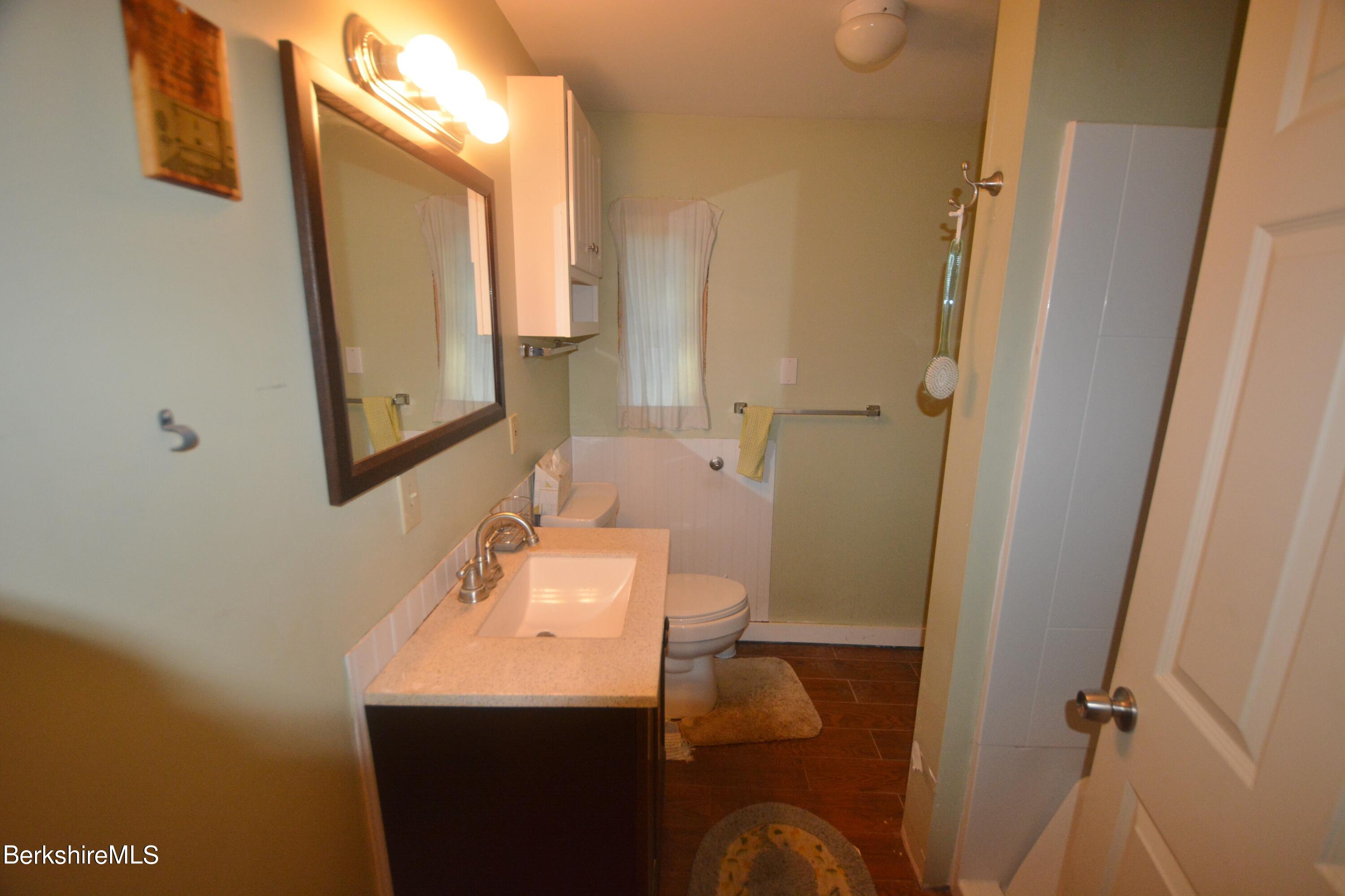 150 Cold Spring Road Sandisfield, MA 01255 - Photo 6 of 9 a bathroom with a sink a toilet and mirror
