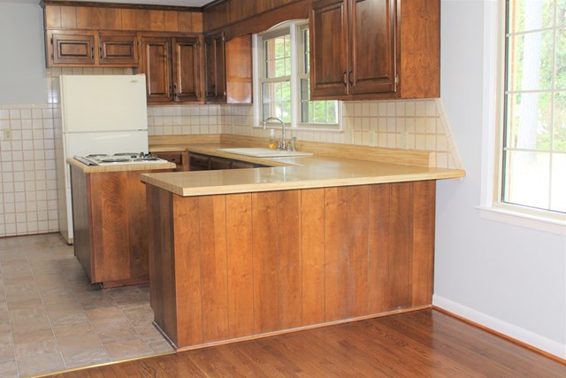 1148 Whiskey Road Aiken, SC 29801 - Photo 2 of 20 a kitchen with granite countertop cabinets stainless steel appliances and a window