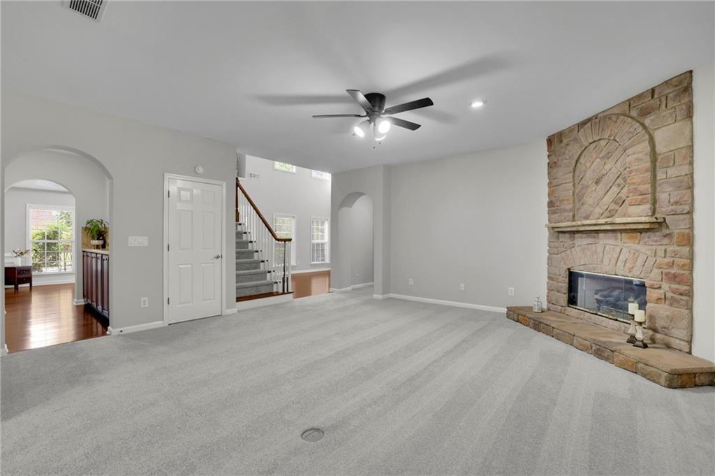 2945 Links View Way Cumming, GA 30041 - Photo 11 of 25 wooden floor fireplace and windows in an empty room