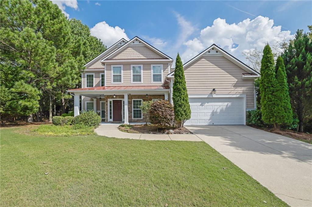 2945 Links View Way Cumming, GA 30041 - Photo 2 of 25 a front view of a house with a yard table and chairs