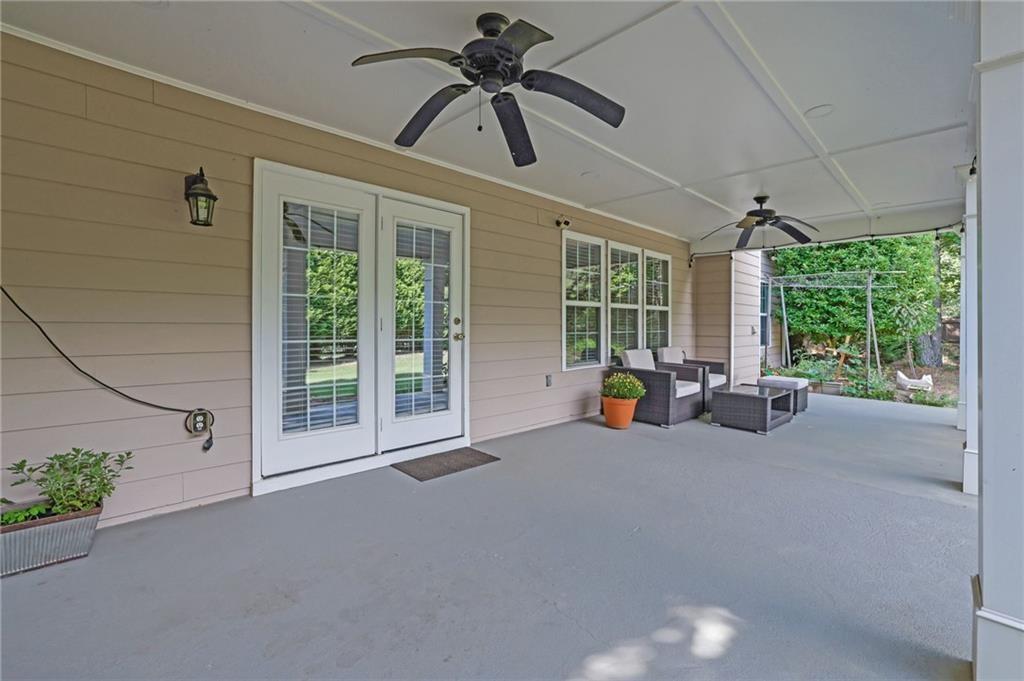 2945 Links View Way Cumming, GA 30041 - Photo 22 of 25 a view of a livingroom with a patio and garden