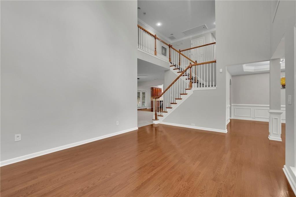 2945 Links View Way Cumming, GA 30041 - Photo 7 of 25 a view of an empty room with wooden floor and stairs