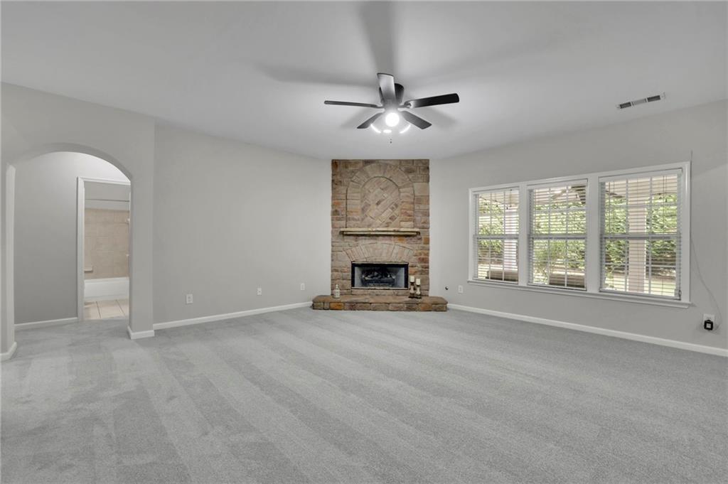 2945 Links View Way Cumming, GA 30041 - Photo 10 of 25 a view of an empty room with a fireplace and a window