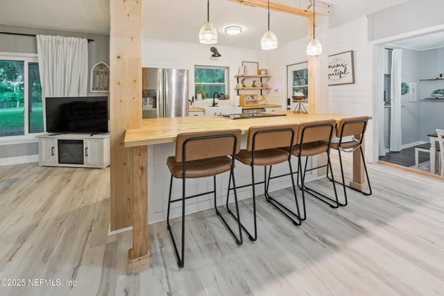 a kitchen with a sink stove and refrigerator