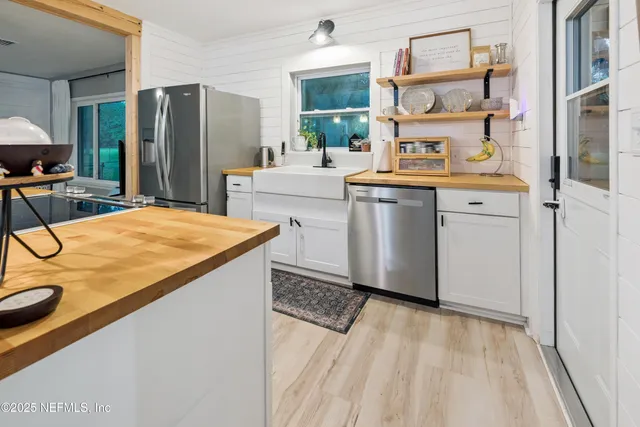 a room with stainless steel appliances kitchen island granite countertop furniture and a kitchen view