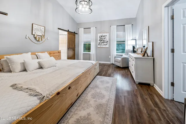 a bathroom with a double vanity sink a mirror and a toilet