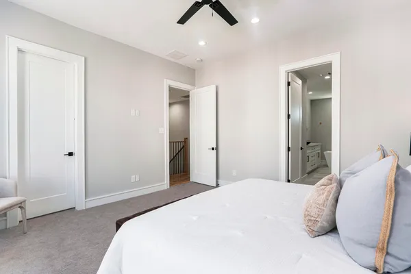 an empty room with a window and a ceiling fan