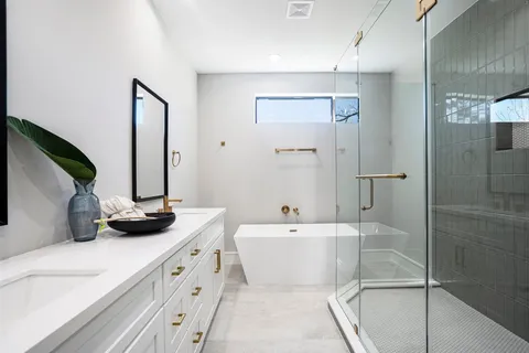 a bathroom with a double vanity sink and mirror