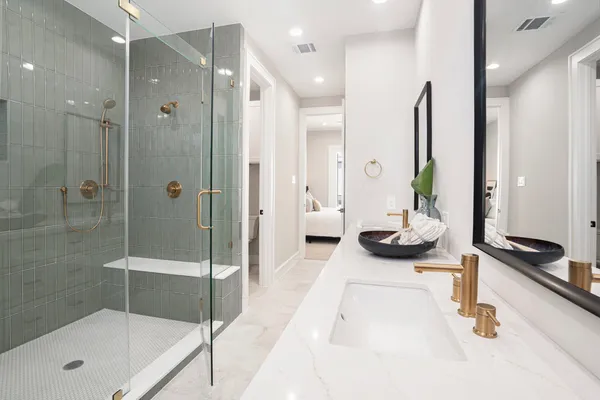 a bathroom with a shower a toilet and a sink