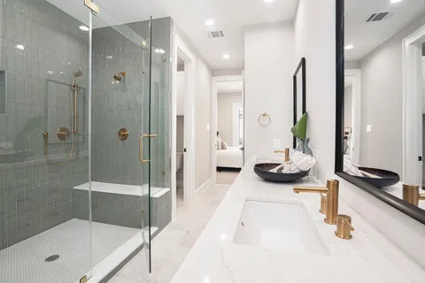 a bathroom with a tub sink and mirror