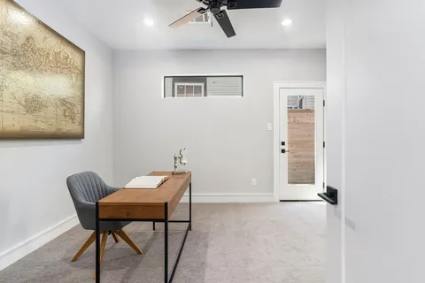 a view of a room with furniture and wooden floor