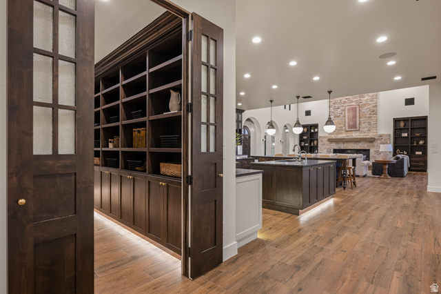 4871 South Homestead Way Washington, UT 84780 - Photo 34 of 151 Corridor with recessed lighting, light wood-style flooring, built in shelves, and arched walkways