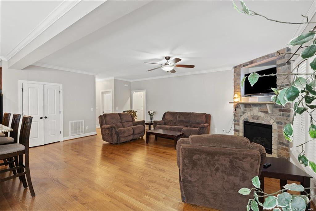 704 Micahs Way North Spring Lake, NC 28390 - Photo 14 of 43 a living room with furniture a fireplace and a flat screen tv