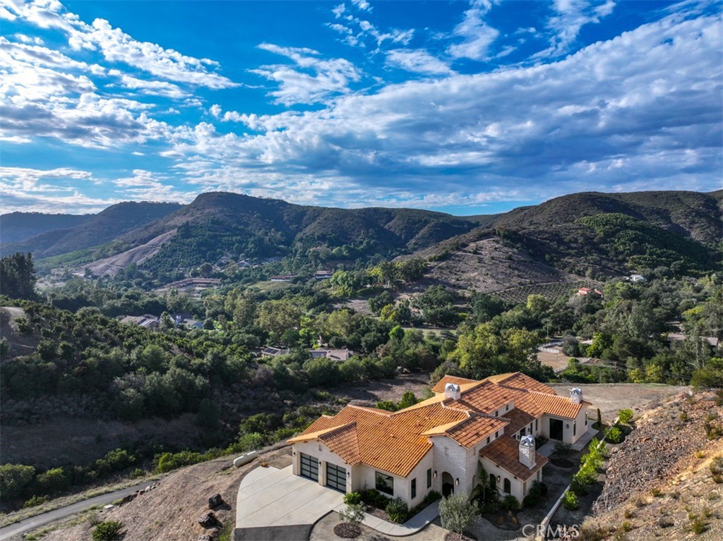 an aerial view of a house with mountain view