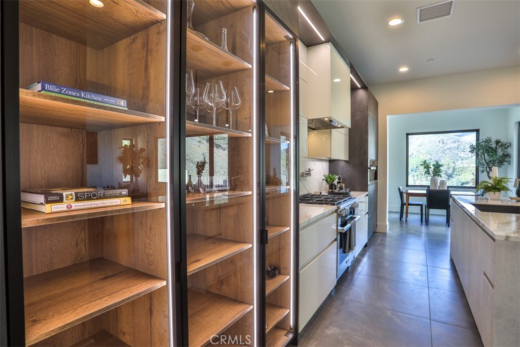 43698 De Luz Road Temecula, CA 92590 - Photo 15 of 60 a kitchen with stainless steel appliances granite countertop a refrigerator and a sink