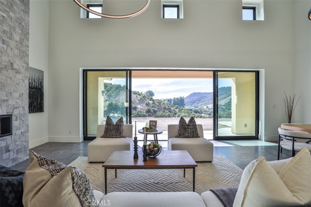 43698 De Luz Road Temecula, CA 92590 - Photo 21 of 60 a living room with furniture and a large window