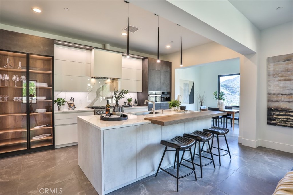 43698 De Luz Road Temecula, CA 92590 - Photo 24 of 60 a kitchen with stainless steel appliances kitchen island a large island in the center