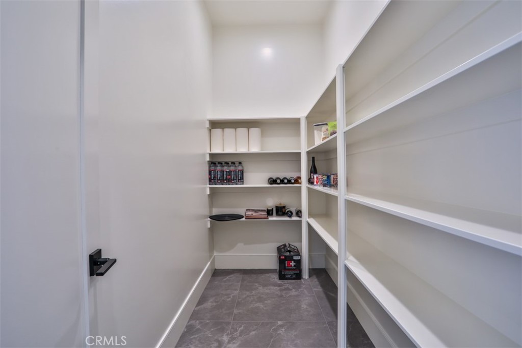 43698 De Luz Road Temecula, CA 92590 - Photo 27 of 60 a view of a kitchen with a refrigerator and a sink