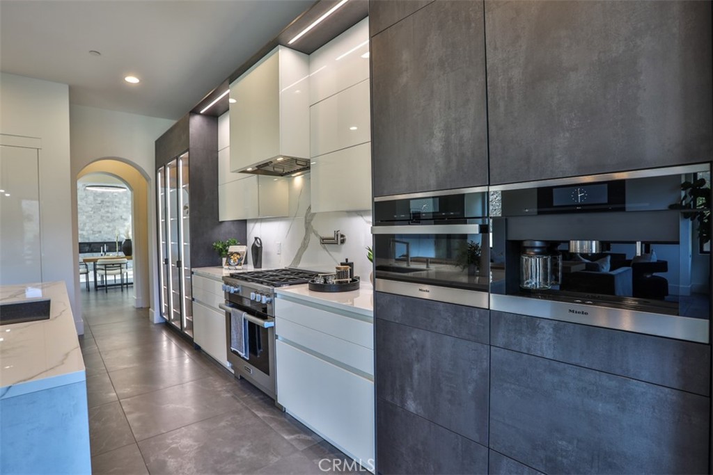 43698 De Luz Road Temecula, CA 92590 - Photo 3 of 60 a kitchen with stainless steel appliances granite countertop a refrigerator a stove and a sink with wooden floor