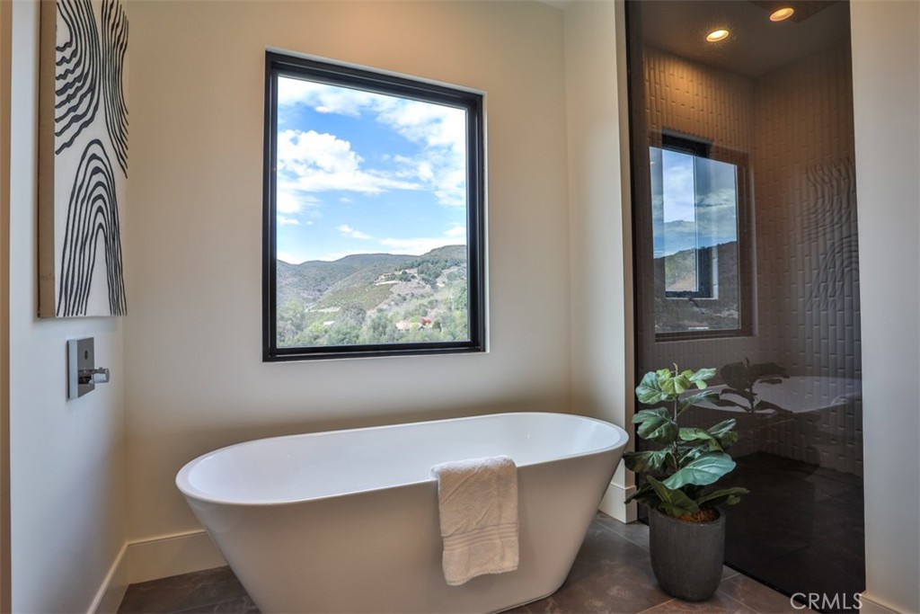 43698 De Luz Road Temecula, CA 92590 - Photo 36 of 60 a white bath tub sitting in a bathroom