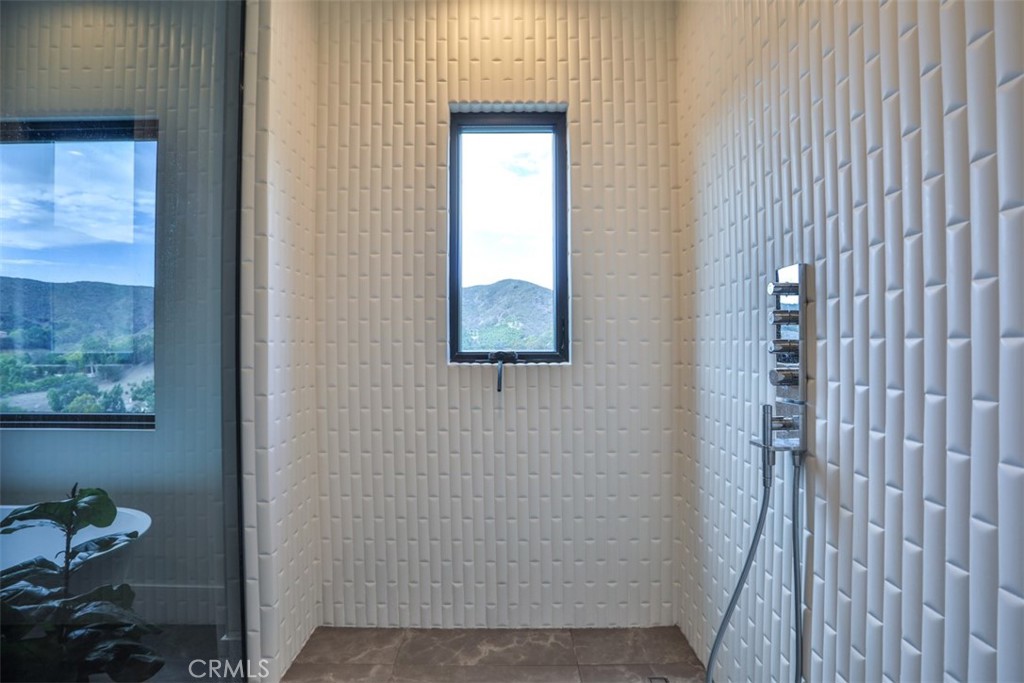 43698 De Luz Road Temecula, CA 92590 - Photo 38 of 60 a bathroom with a shower and a window