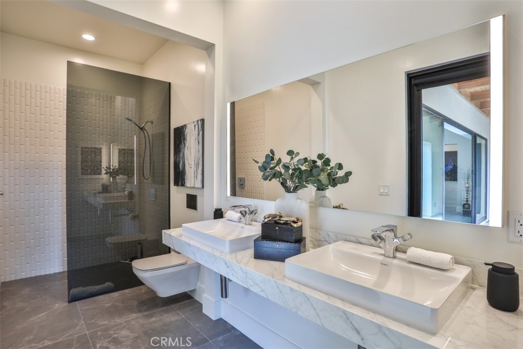43698 De Luz Road Temecula, CA 92590 - Photo 42 of 60 a bathroom with a double vanity sink toilet and shower