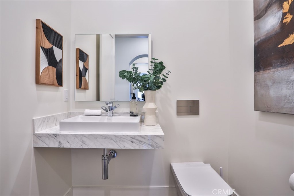 43698 De Luz Road Temecula, CA 92590 - Photo 46 of 60 a bathroom with a toilet sink and mirror