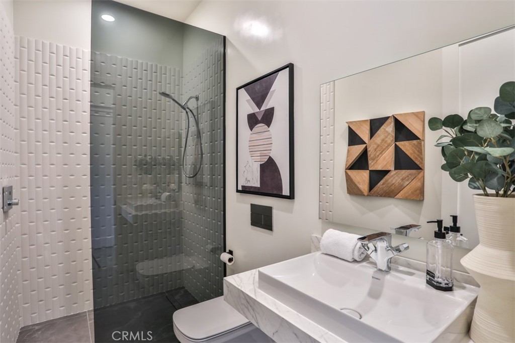 43698 De Luz Road Temecula, CA 92590 - Photo 48 of 60 a bathroom with a sink toilet and shower