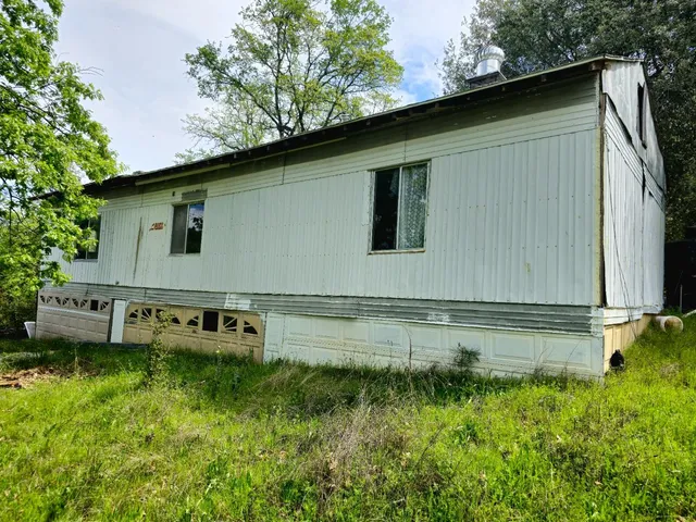 a view of a backyard with plants and a patio