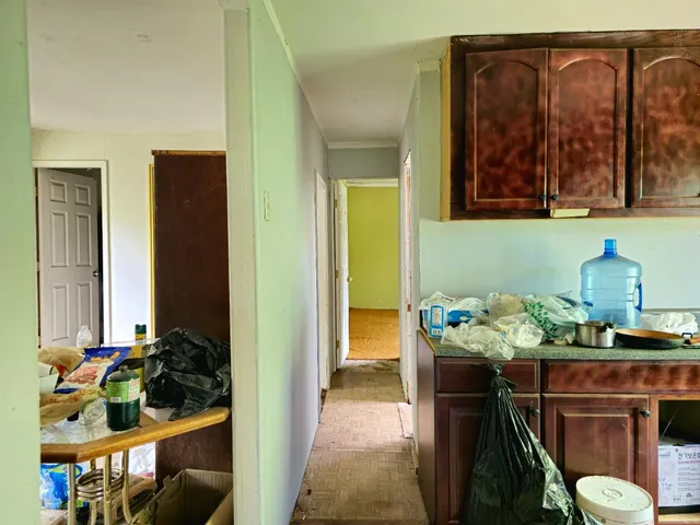 a backyard of a house with table and chairs