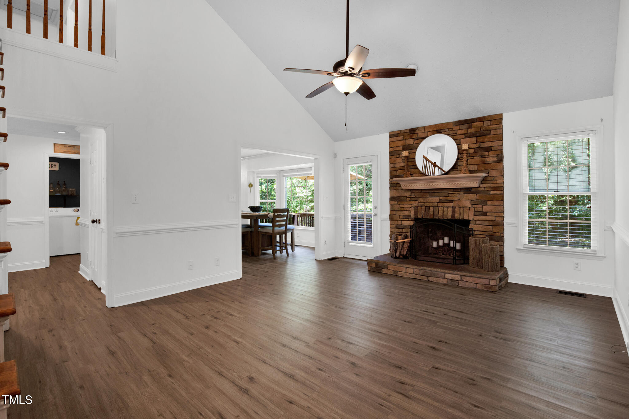 7832 Shuttle Road Fayetteville, NC 28311 - Photo 1 of 35 a view of an empty room with wooden floor a fireplace and a window