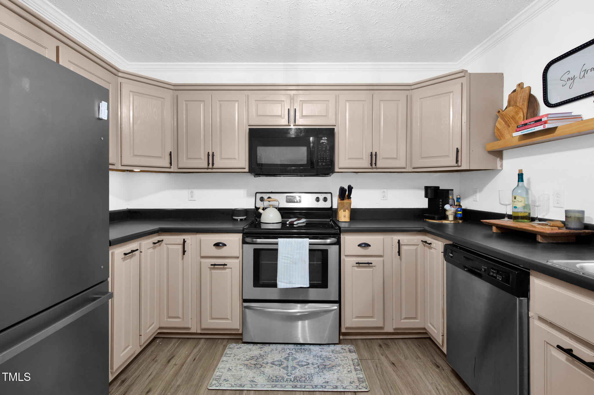 7832 Shuttle Road Fayetteville, NC 28311 - Photo 18 of 35 a kitchen with stainless steel appliances granite countertop a stove microwave and sink