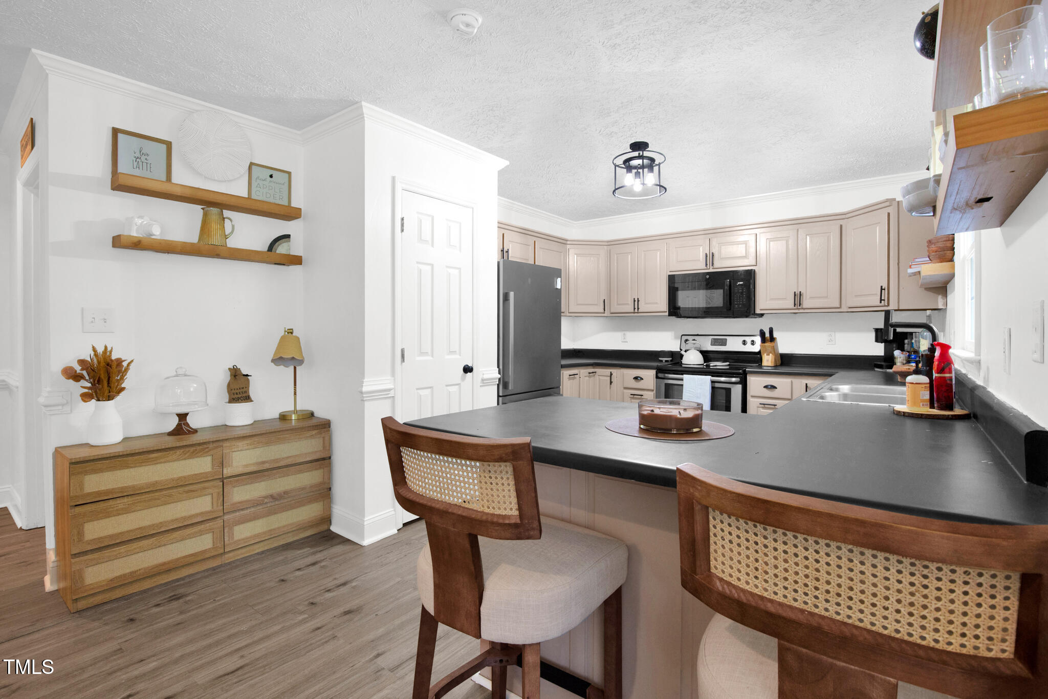 7832 Shuttle Road Fayetteville, NC 28311 - Photo 19 of 35 a kitchen with appliances a counter space and a dining table