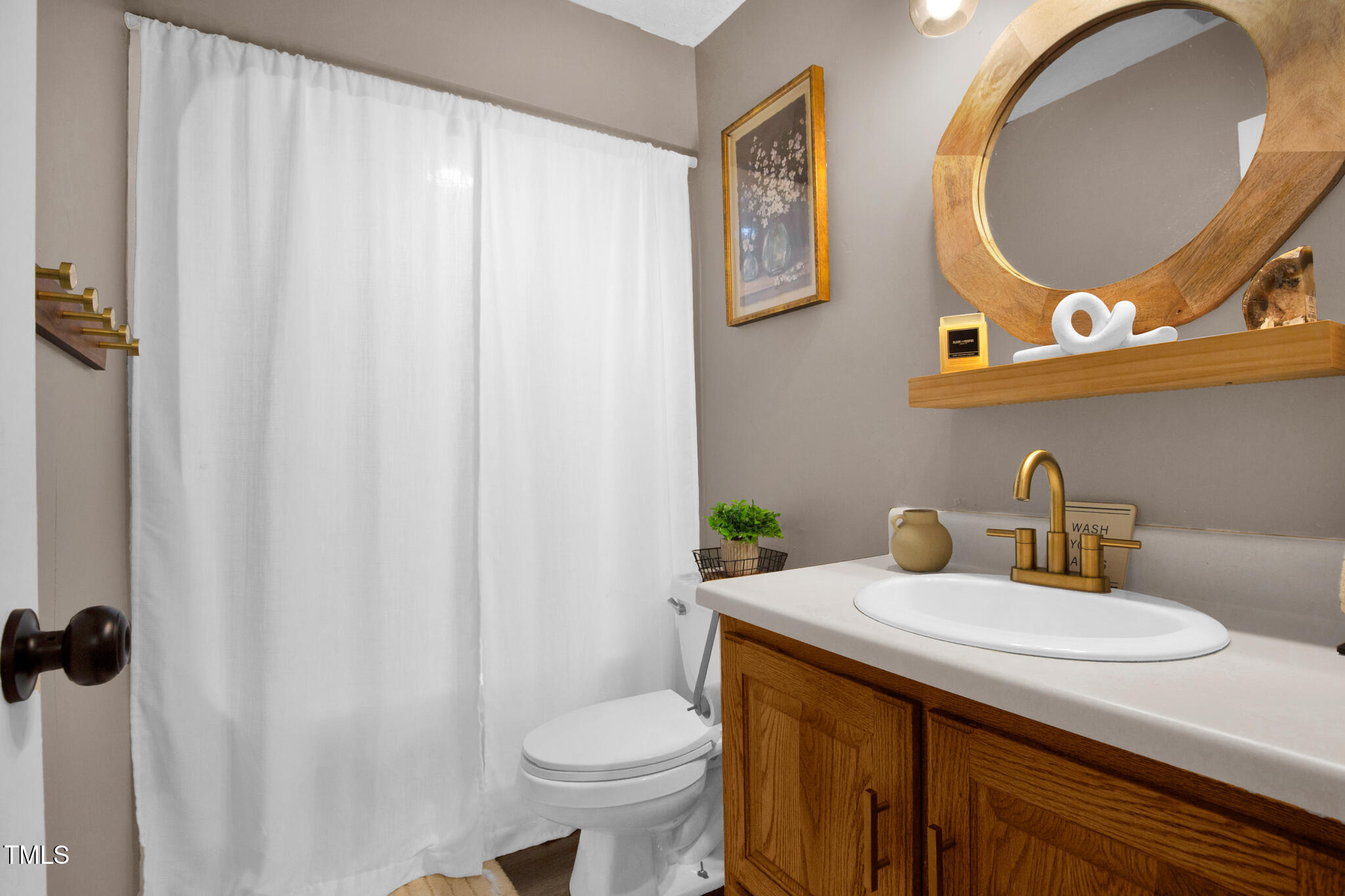 7832 Shuttle Road Fayetteville, NC 28311 - Photo 24 of 35 a bathroom with a sink a toilet and a mirror
