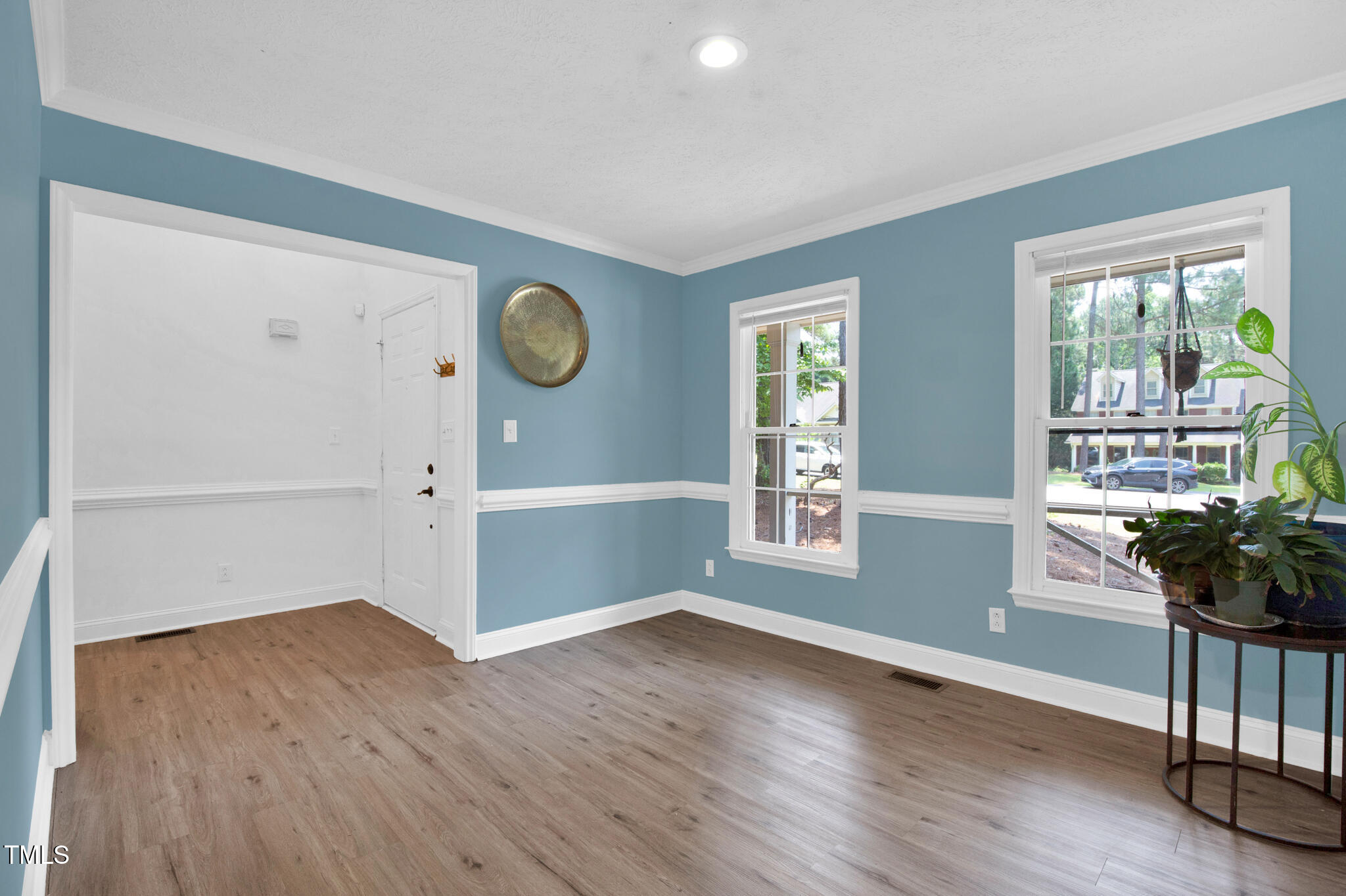 7832 Shuttle Road Fayetteville, NC 28311 - Photo 7 of 35 an empty room with wooden floor and windows