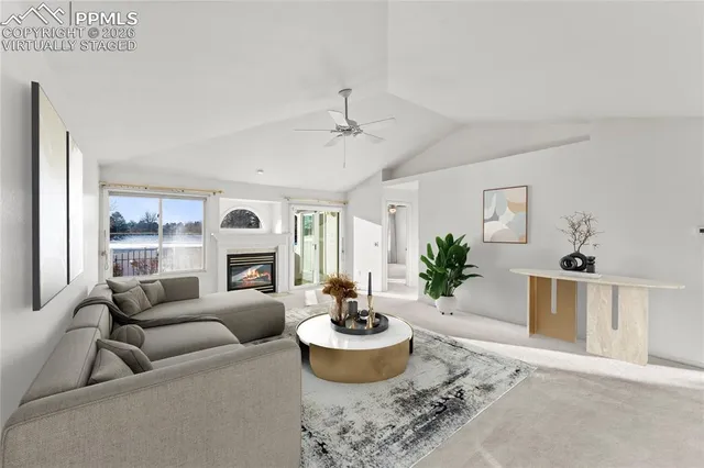 an empty room with windows and fireplace