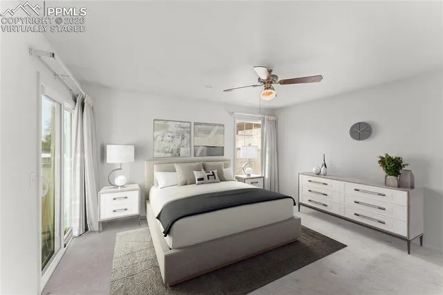 a view of a livingroom with a ceiling fan and window