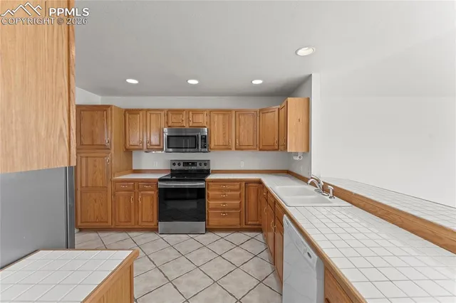 a kitchen with a refrigerator and table