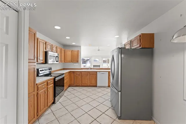 a kitchen with stainless steel appliances a refrigerator sink and cabinets