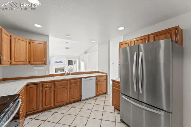 an empty room with windows and fireplace