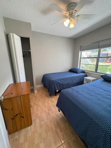 a bedroom with two beds and a chandelier