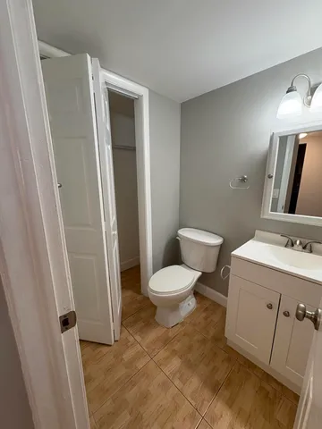 a bathroom with a toilet sink and vanity