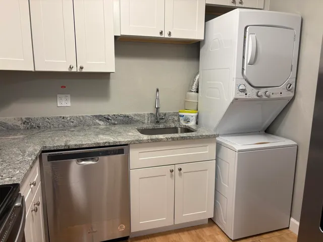 a kitchen with cabinets and a stove top oven
