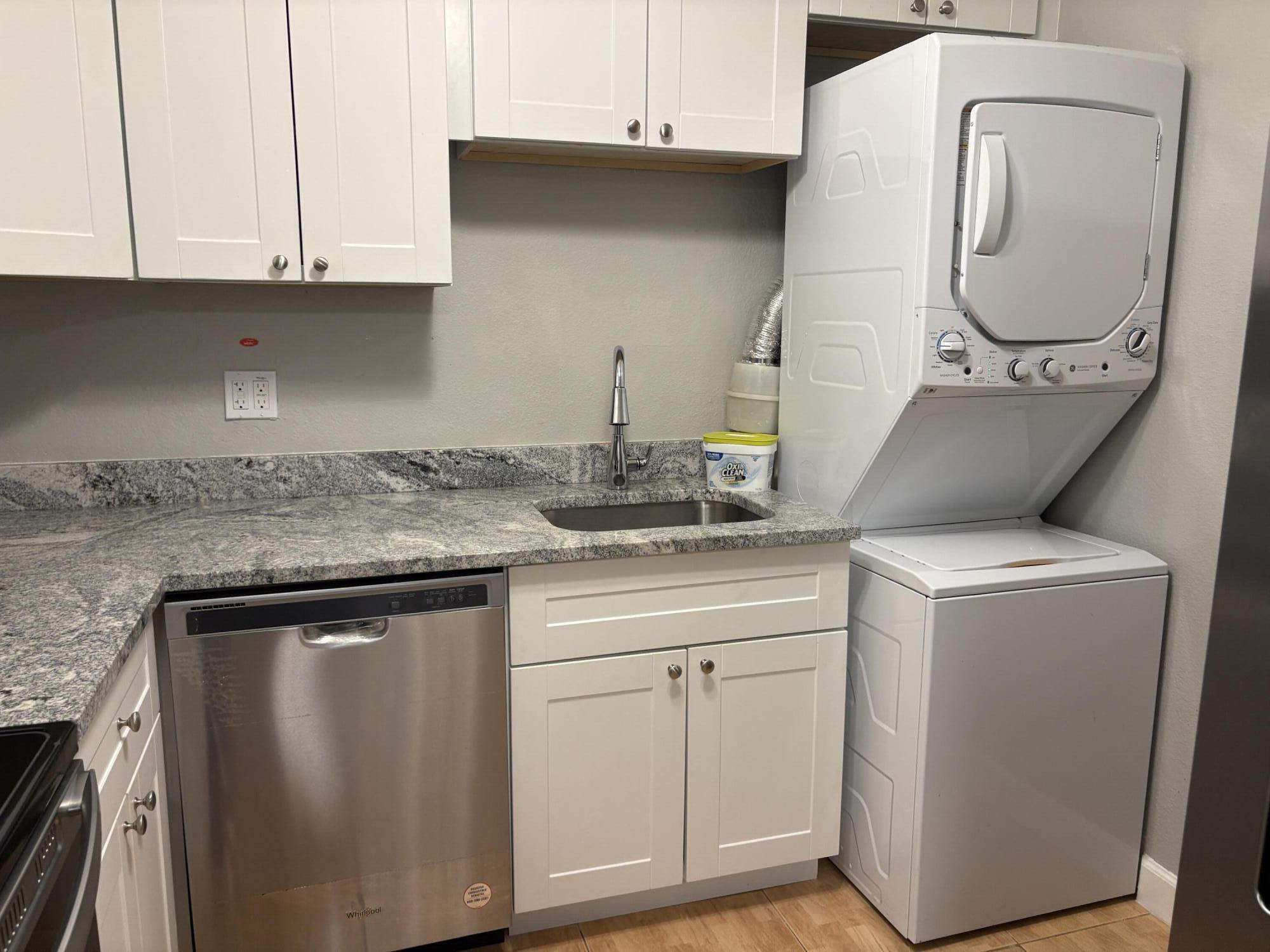 102 Stratford H, Unit A West Palm Beach, FL 33417 - Photo 8 of 19 a kitchen with cabinets and a stove top oven