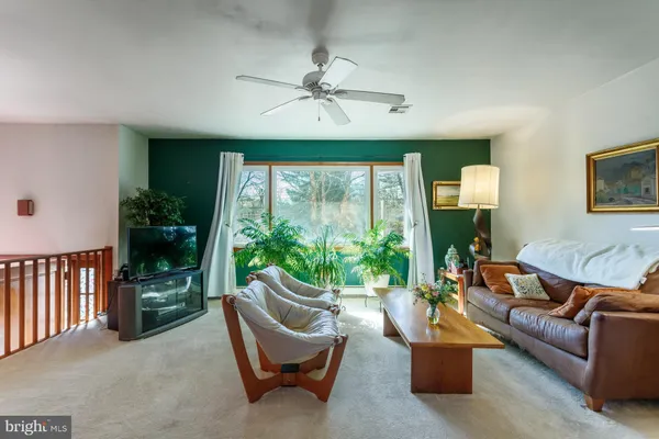 a bedroom with a bed and closet with mirror